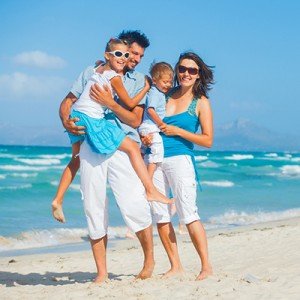 a happy family playing on the beach